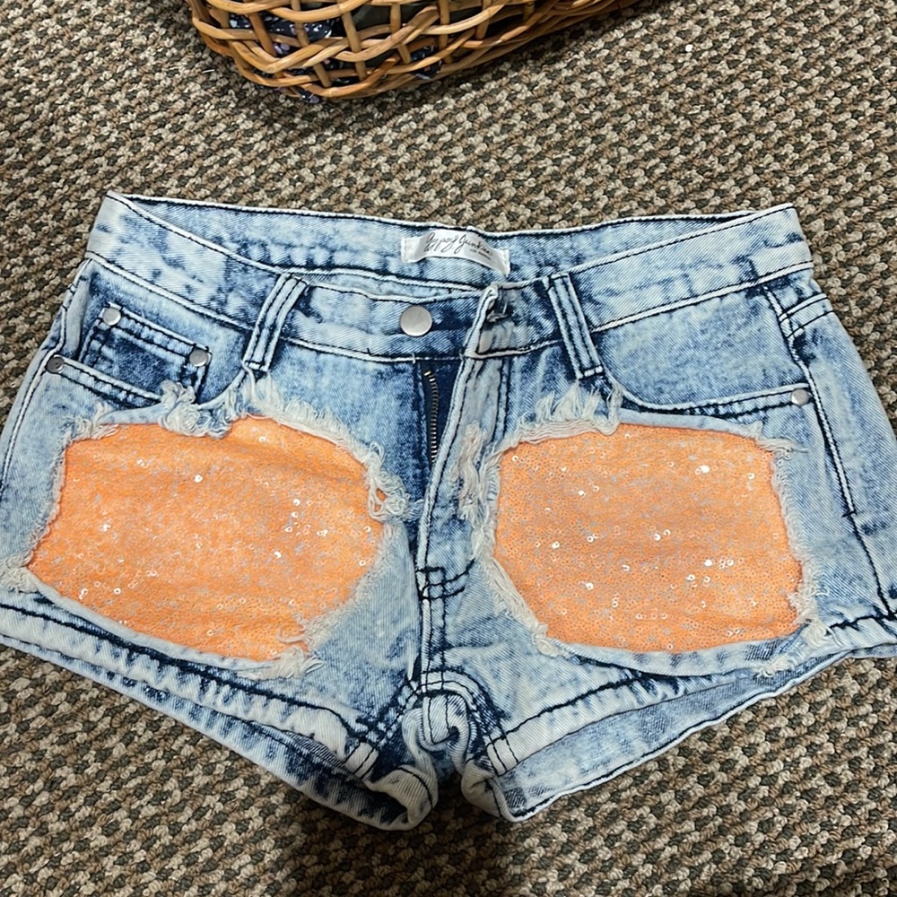 Blue jean shorts with orange patches